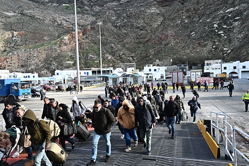 a group of people walking down a dock
