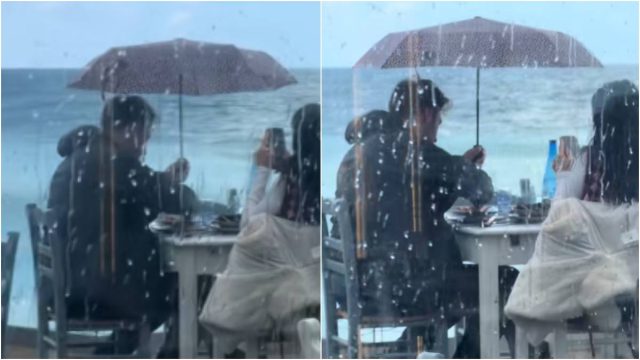 Το είδαμε κι αυτό: Ζευγάρι τρώει πρώτο…. τραπέζι μπροστά στη θάλασσα κρατώντας ομπρέλα για να μην βρέχεται!