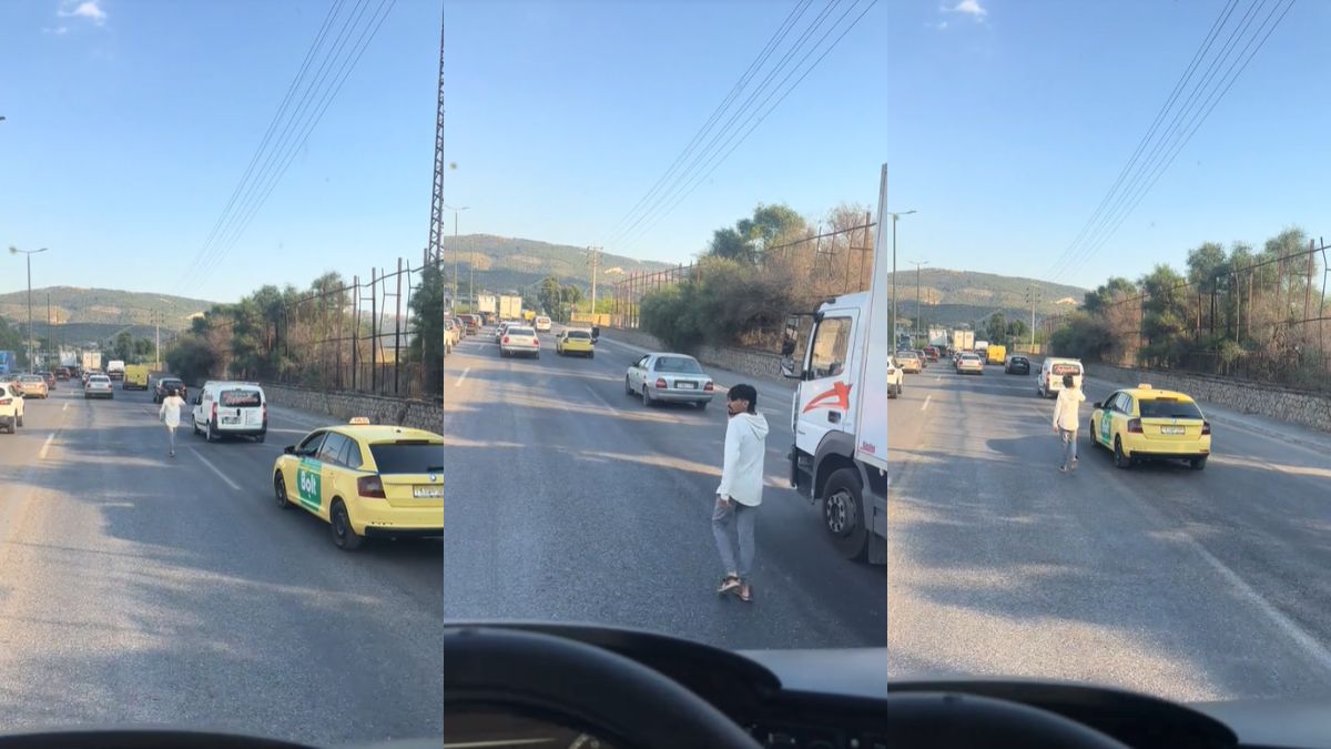 Δεν είμαστε καλά: Τύπος μιλάει στο τηλέφωνο και περπατάει μέσα στη μέση Εθνικής Οδού
